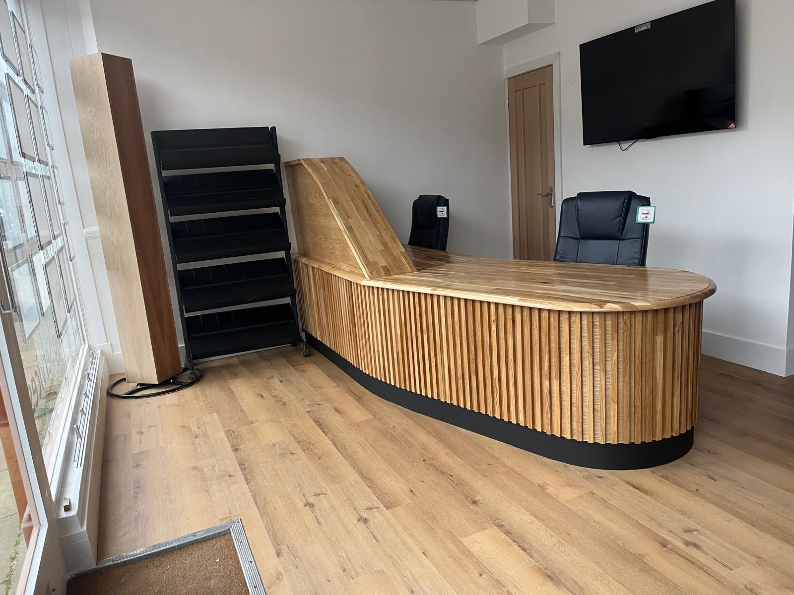 Curved timber reception desk at the LJB Green Street office
