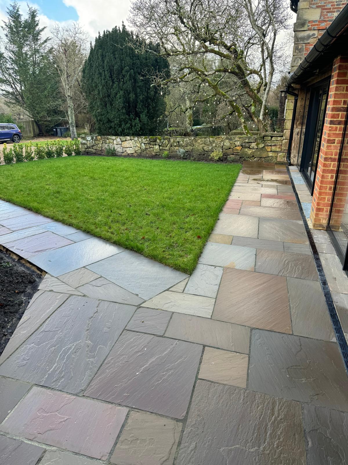 Finished sandstone patio outside the converted garage