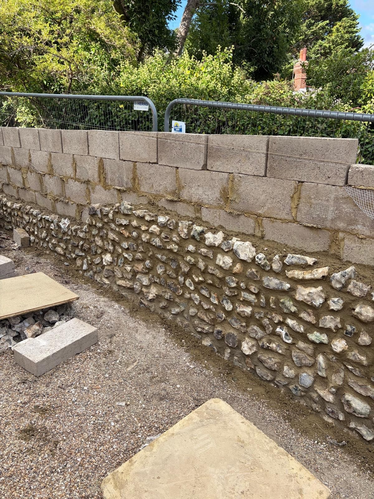 Flint boundary wall during structural rebuilding