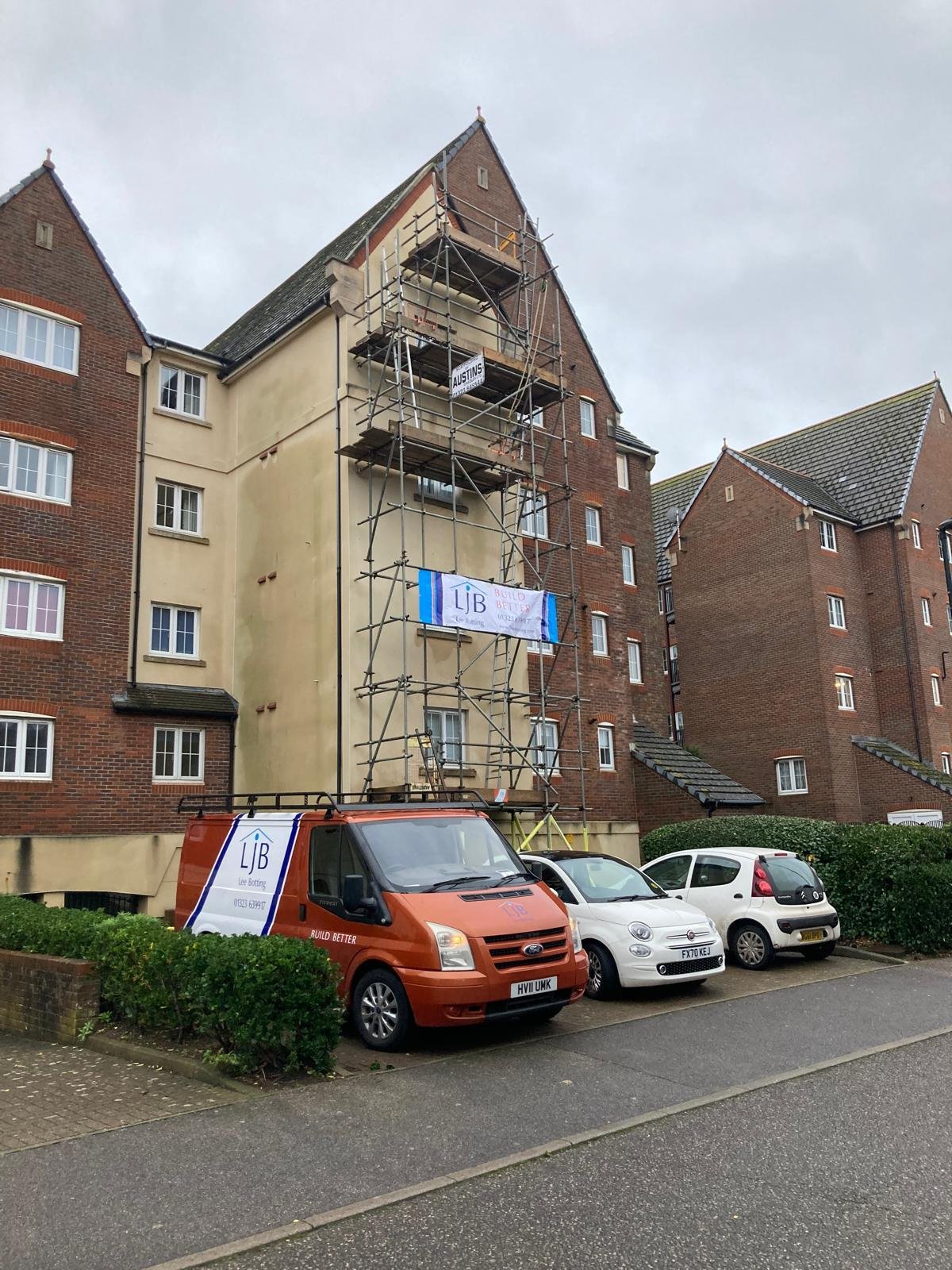 LJB vans outside a scaffolded multi-storey building in Eastbourne