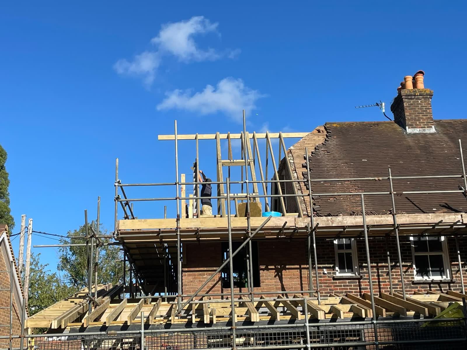 Front view of a home extension roof structure under construction