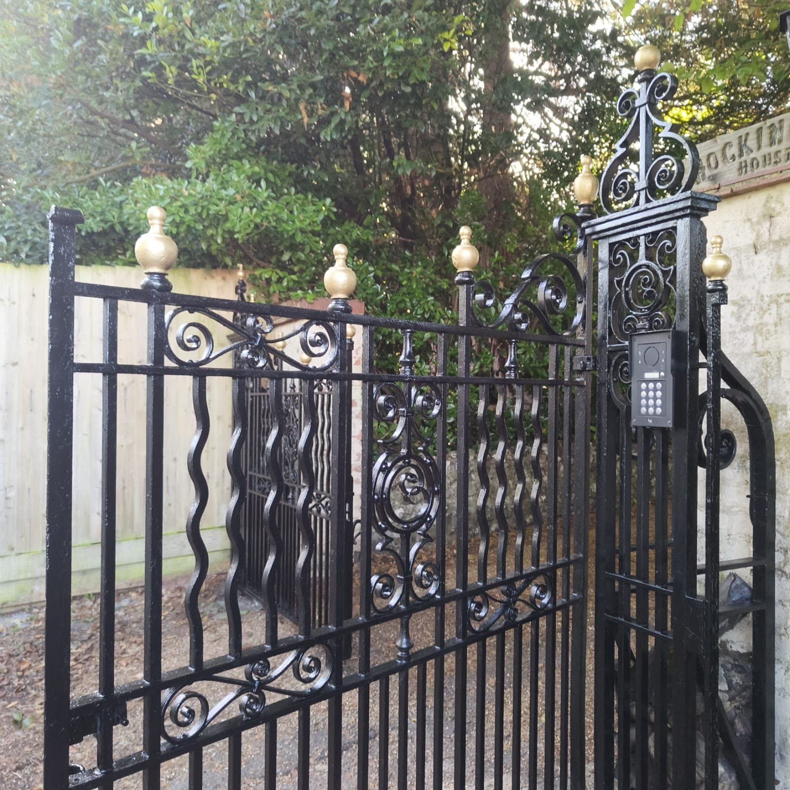 Traditional driveway gate upgraded with discreet access controls