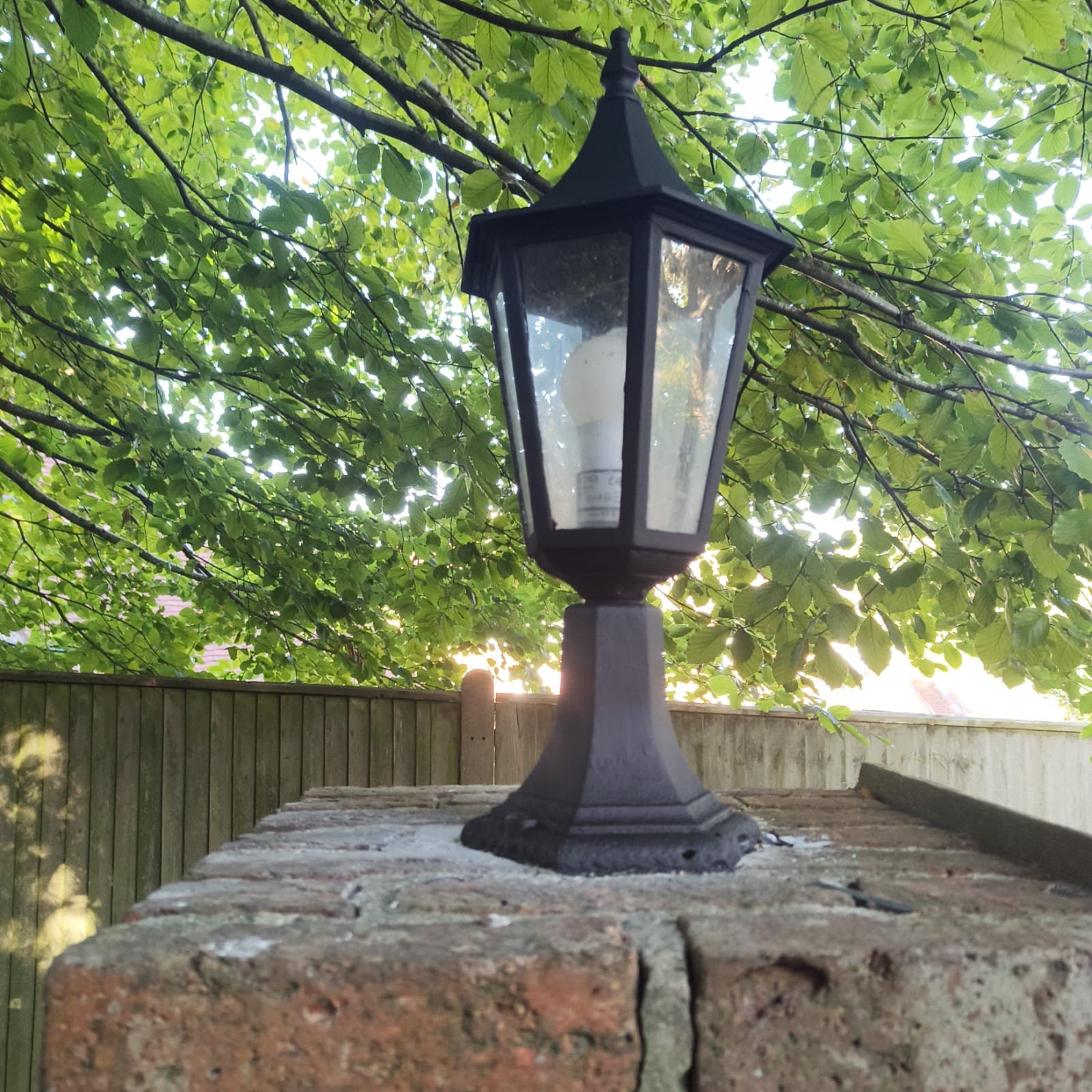 Restored entrance pier finished with a traditional lantern