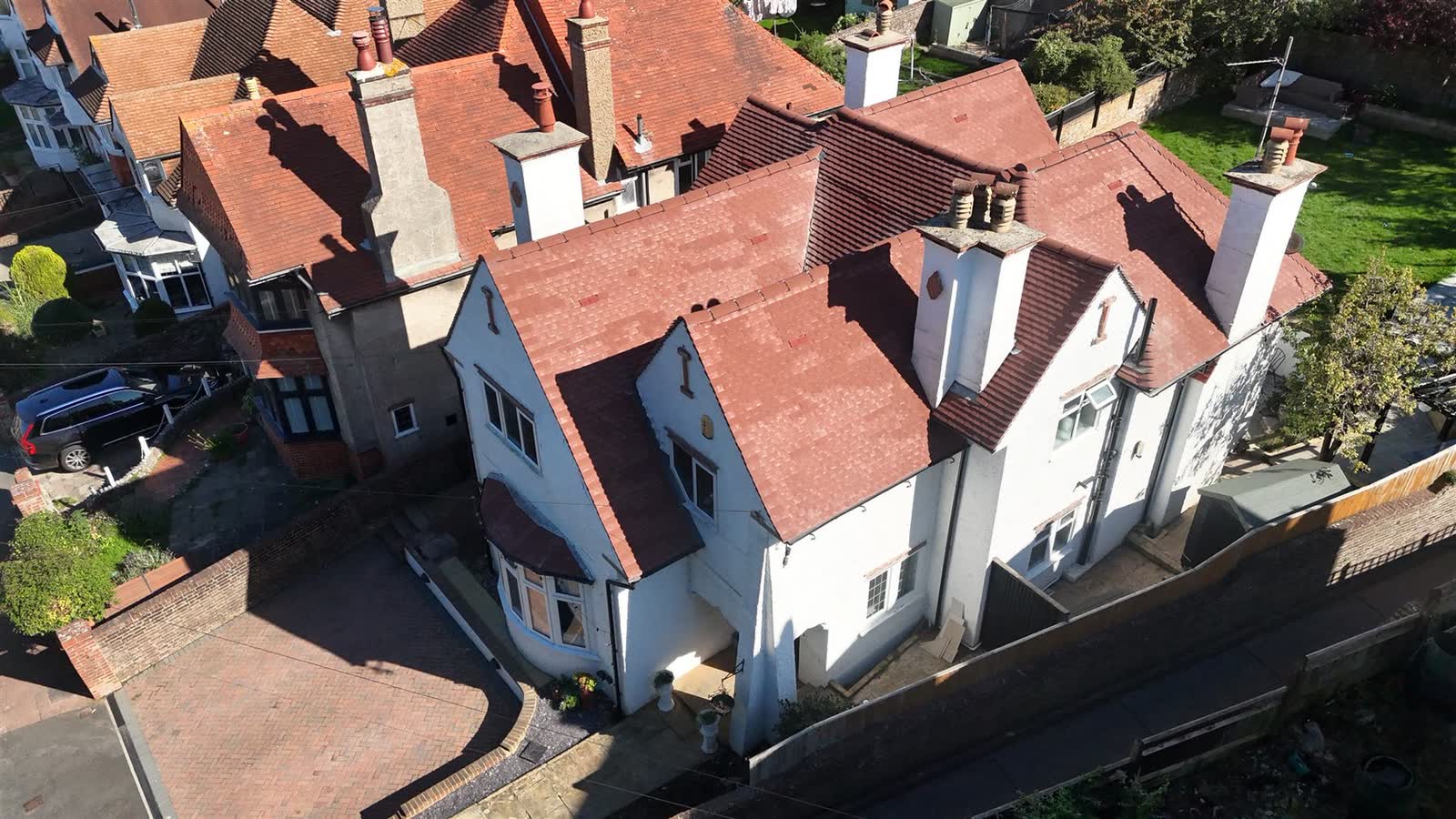 Aerial view of a period home's tiled roof and chimney details