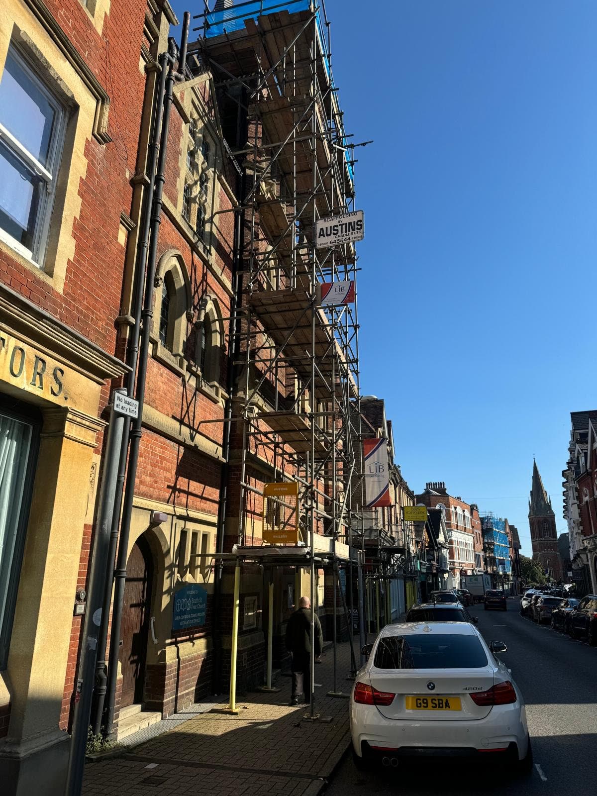 Town-centre building with scaffolding for planned external works