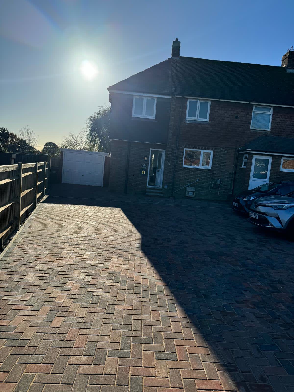 New block-paved driveway with timber boundary fencing