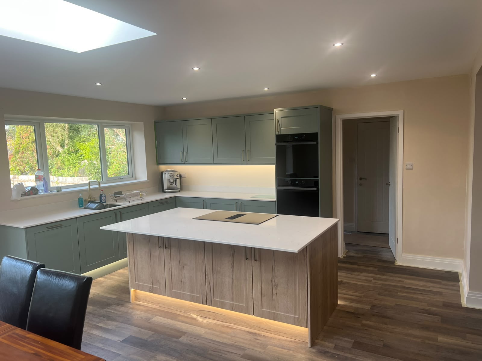 Completed green fitted kitchen with central island in an East Sussex home