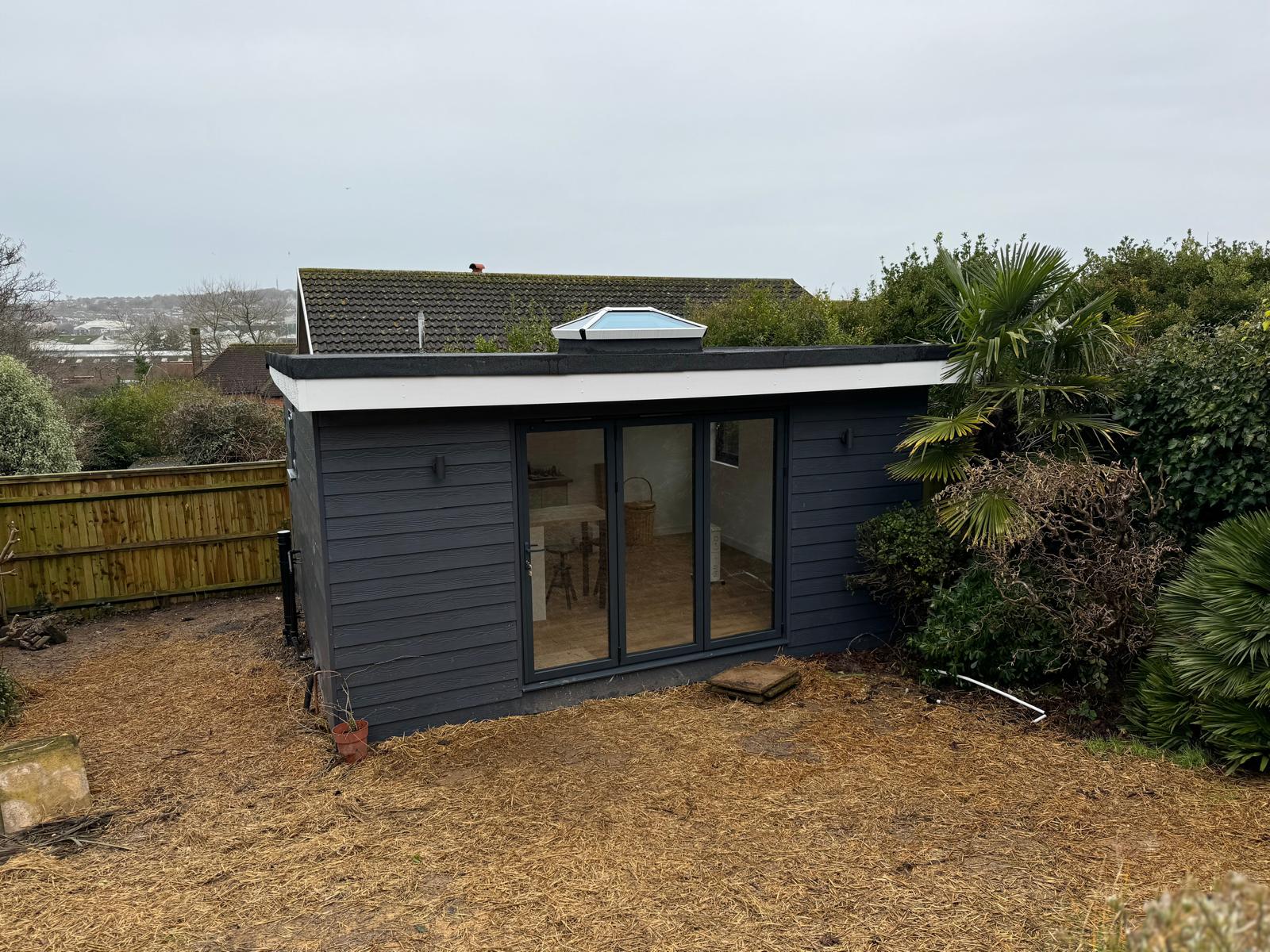 Finished dark-clad garden room with double glazed doors