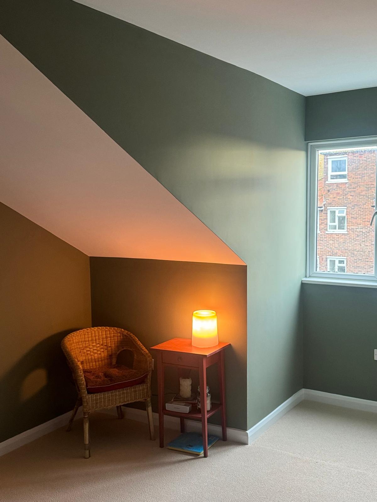 Finished loft room with fitted lighting and a sloping ceiling