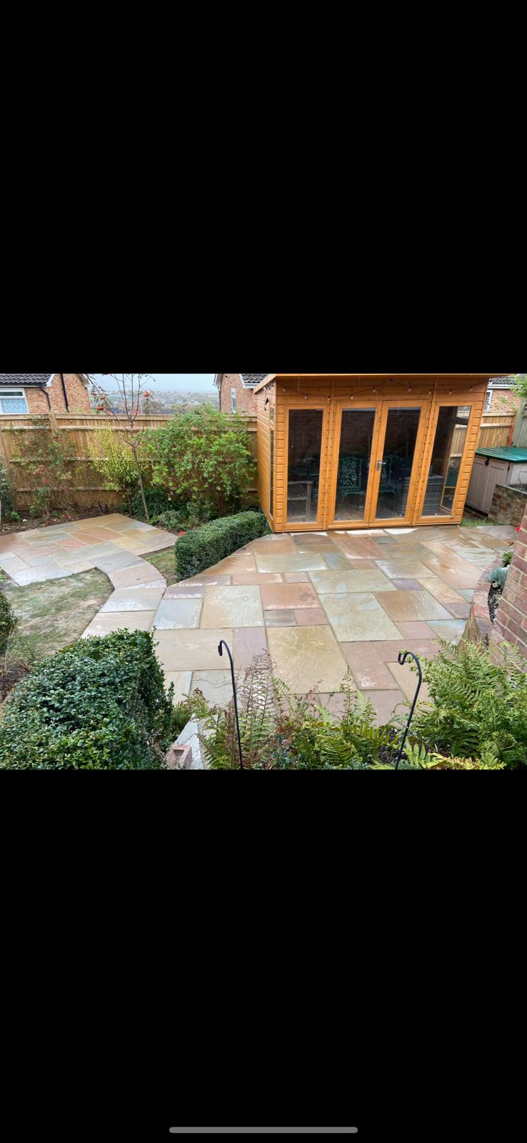 Landscaped garden patio with curved paving