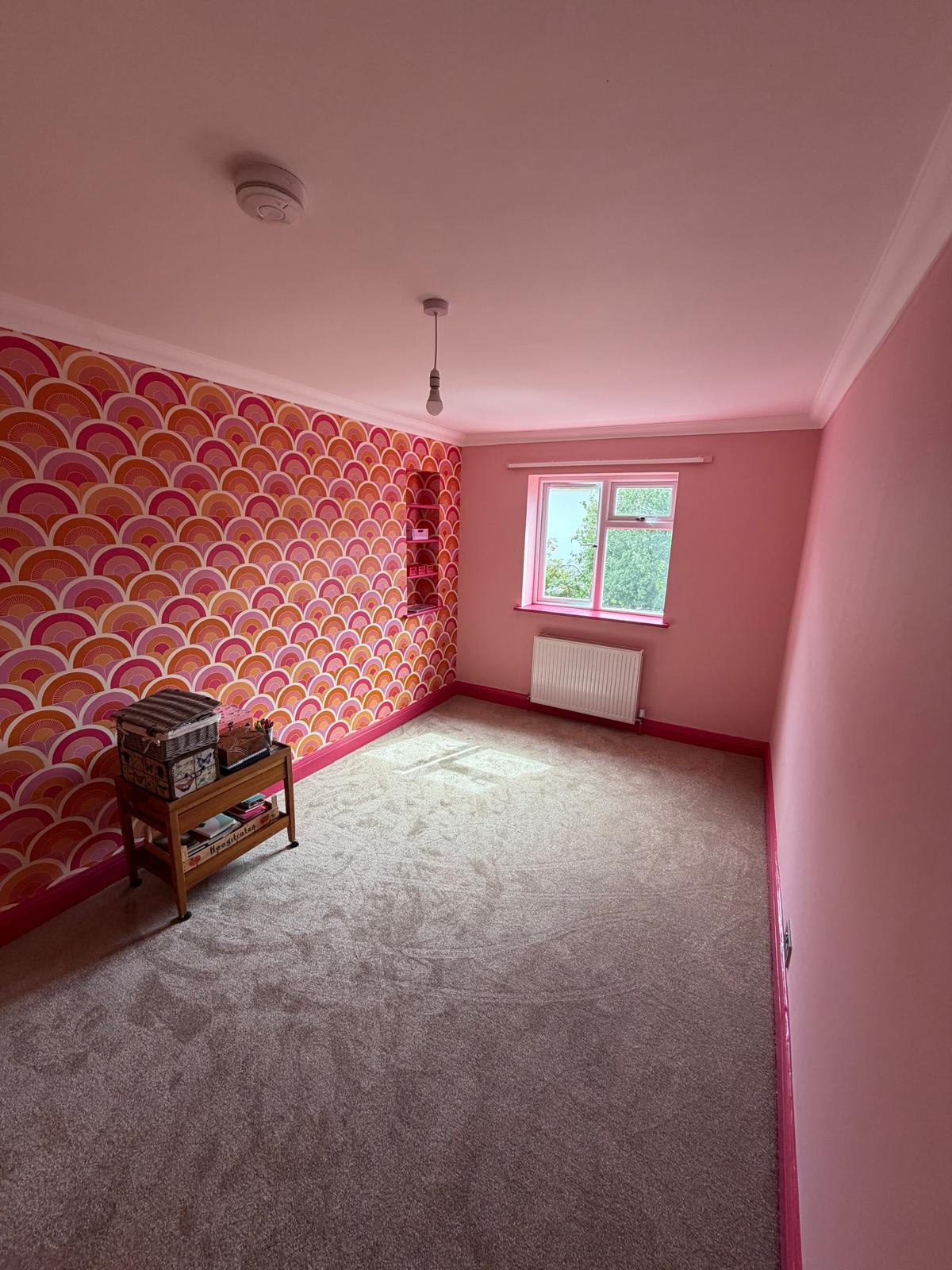 Freshly decorated bedroom with a patterned feature wall