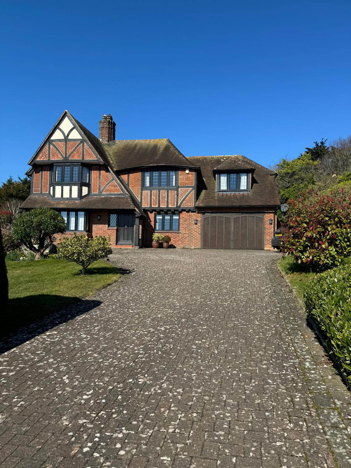 Period-style home with a large finished driveway