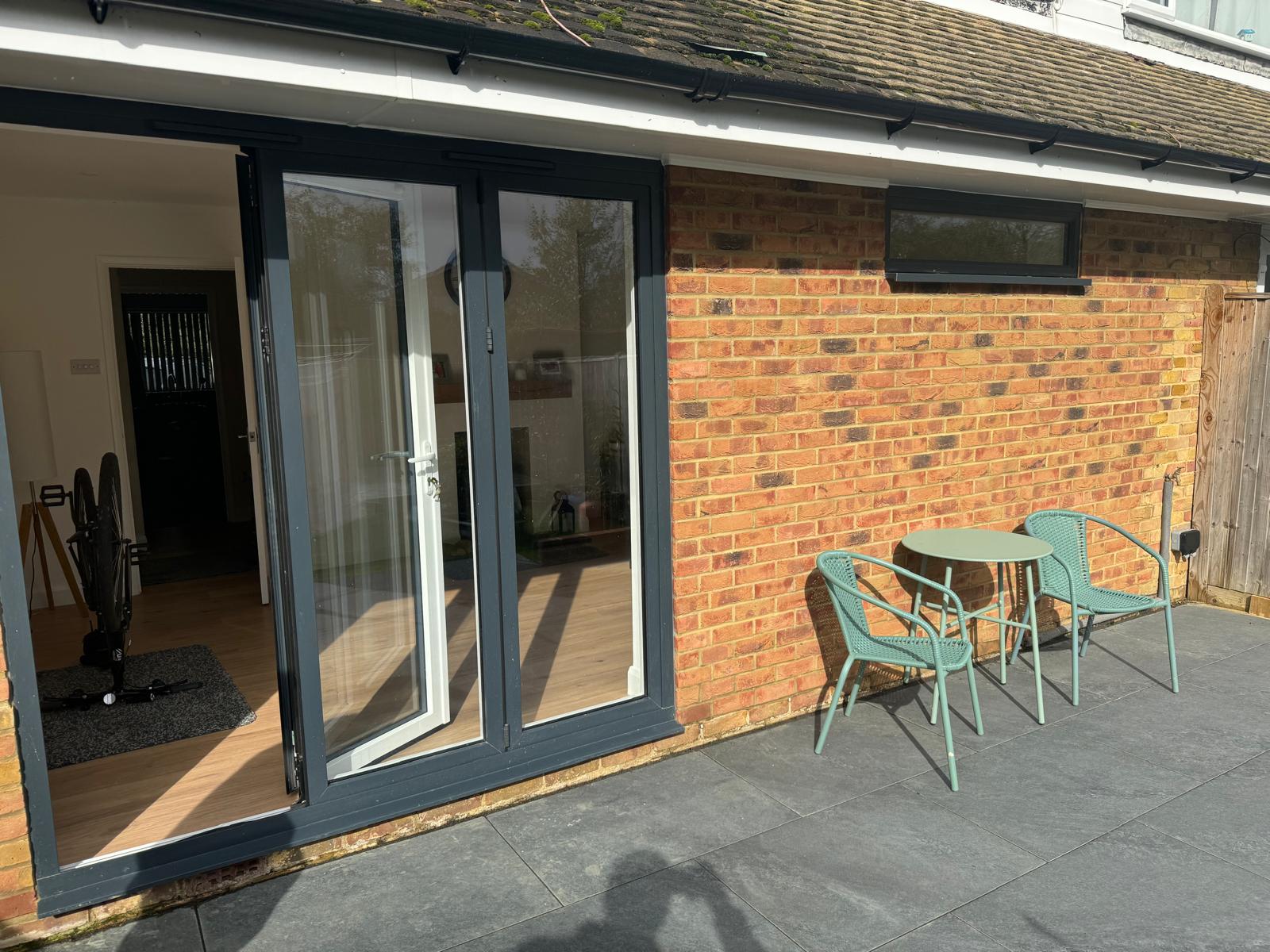 Finished rear extension with bifold doors opening onto a paved patio