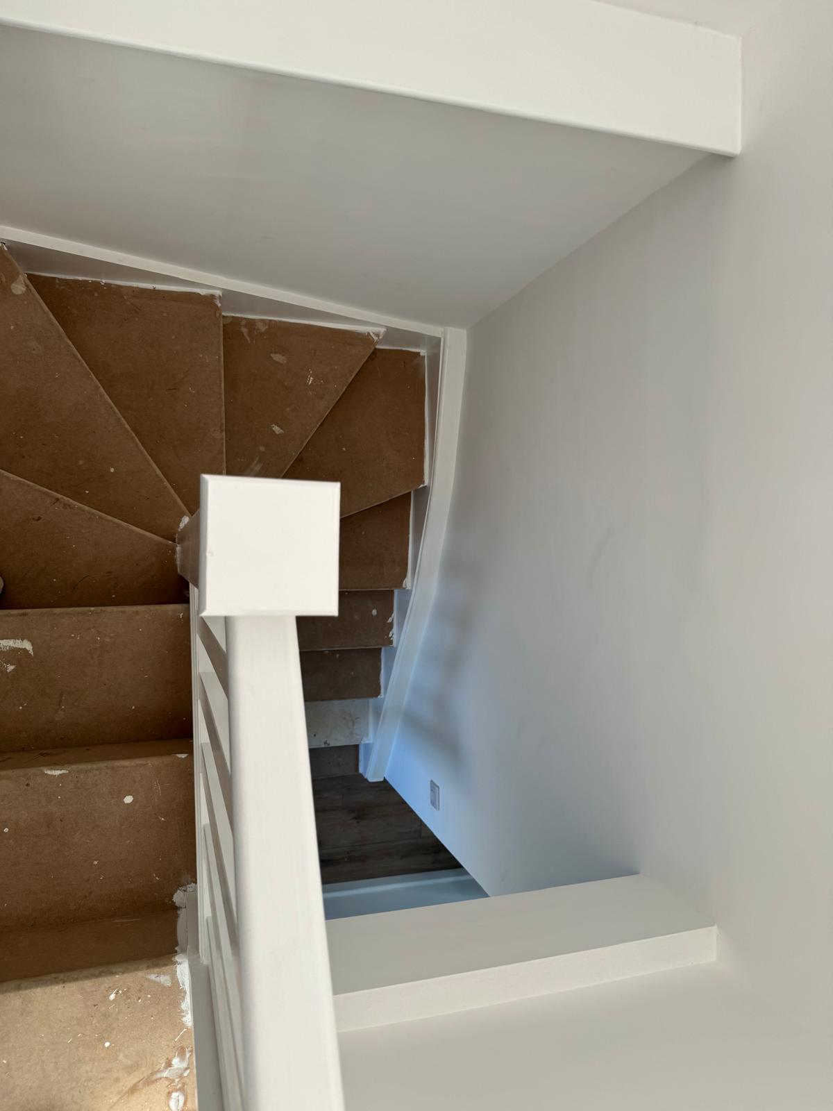 Bespoke geometric carpentry panelling beside a staircase