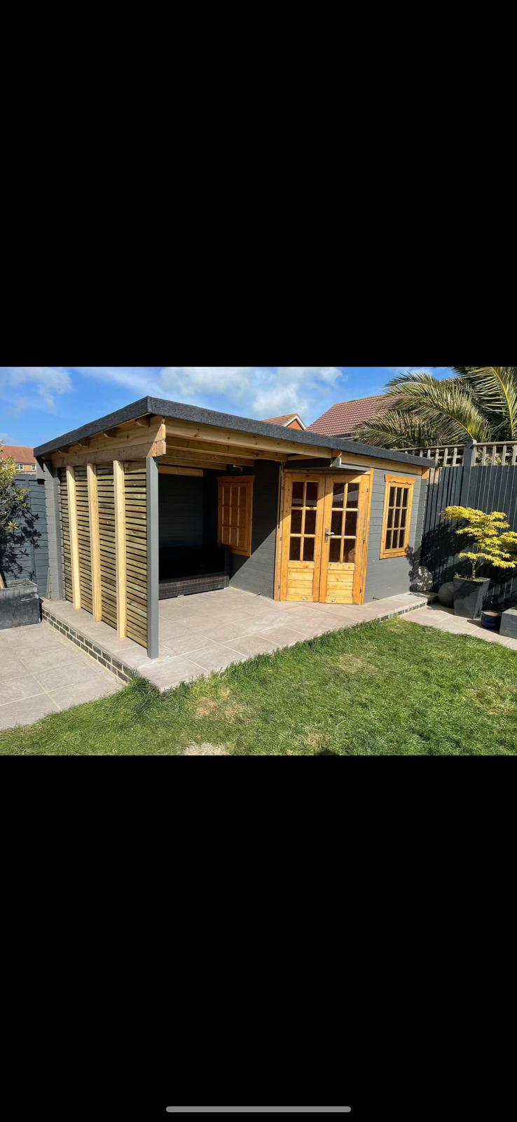 Completed timber summerhouse with double doors and side store